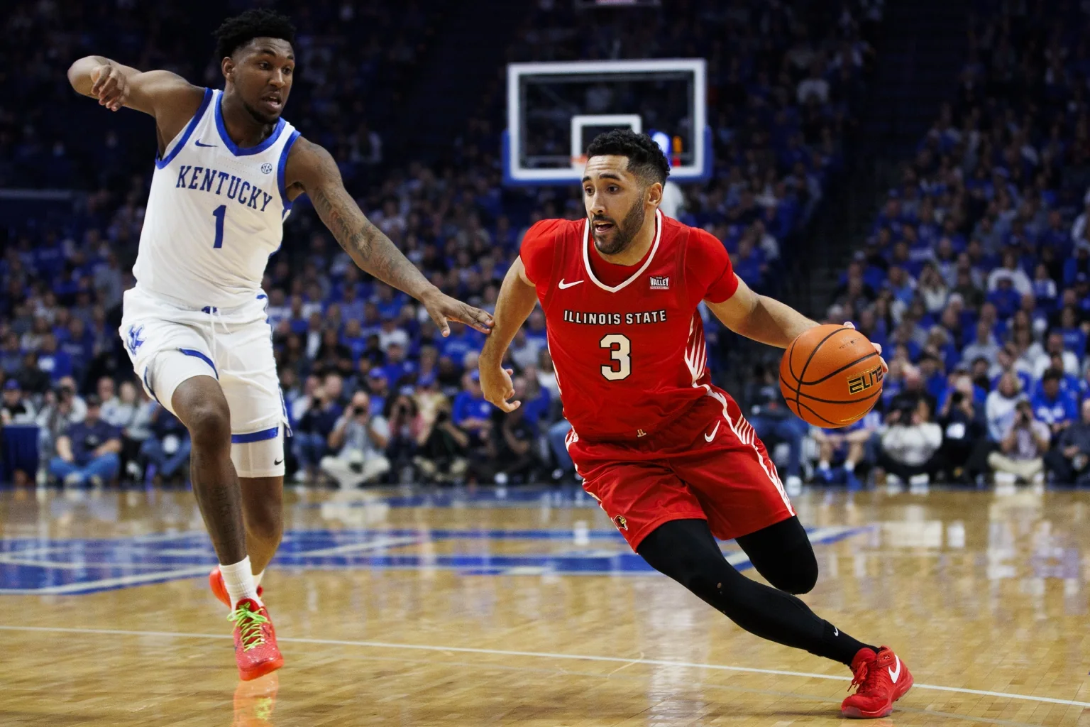 Dalton Banks driving with the basketball against Kentucky while playing for Illinois State