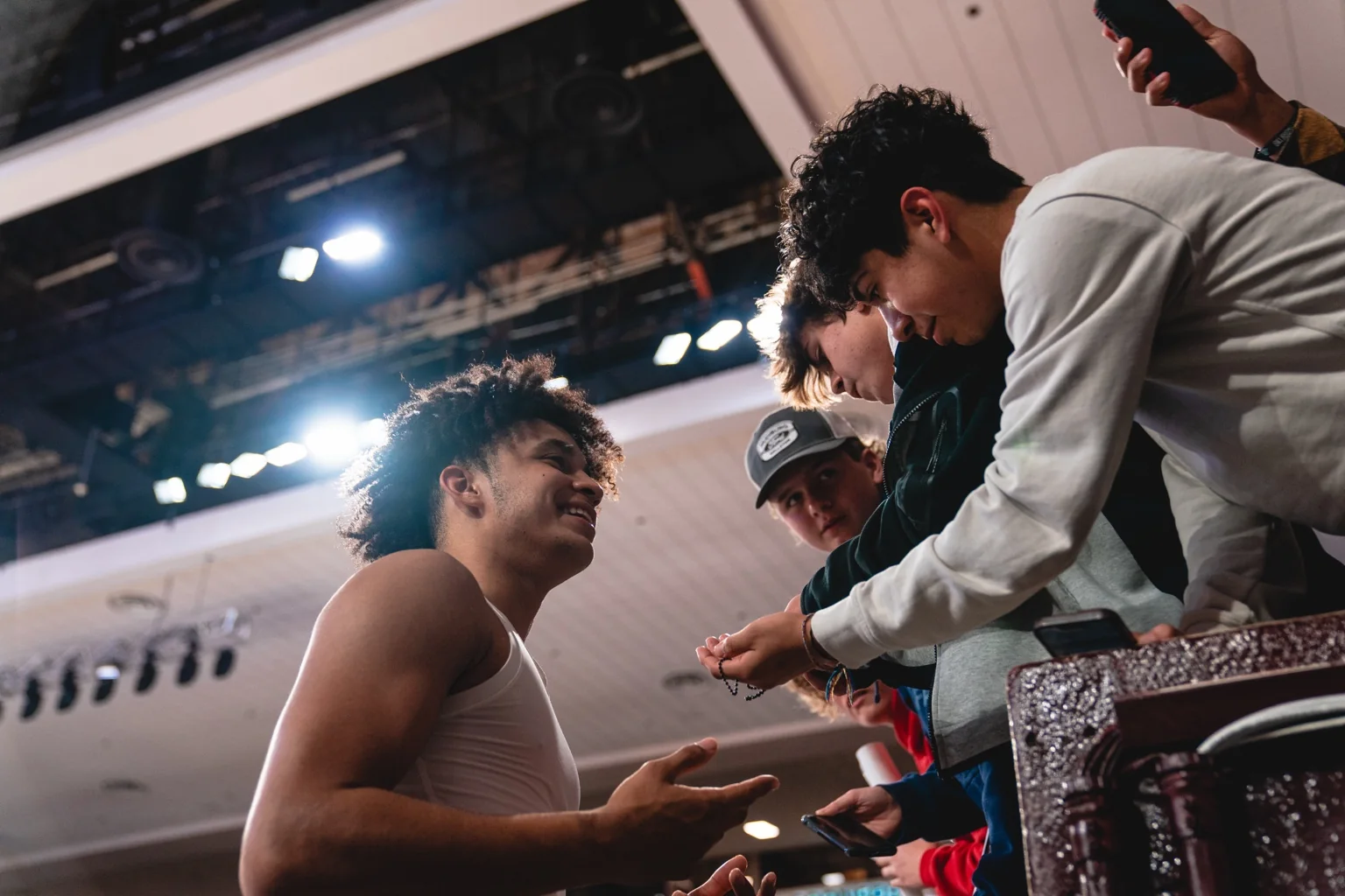 Jalen Hill talking with young basketball fans after a game