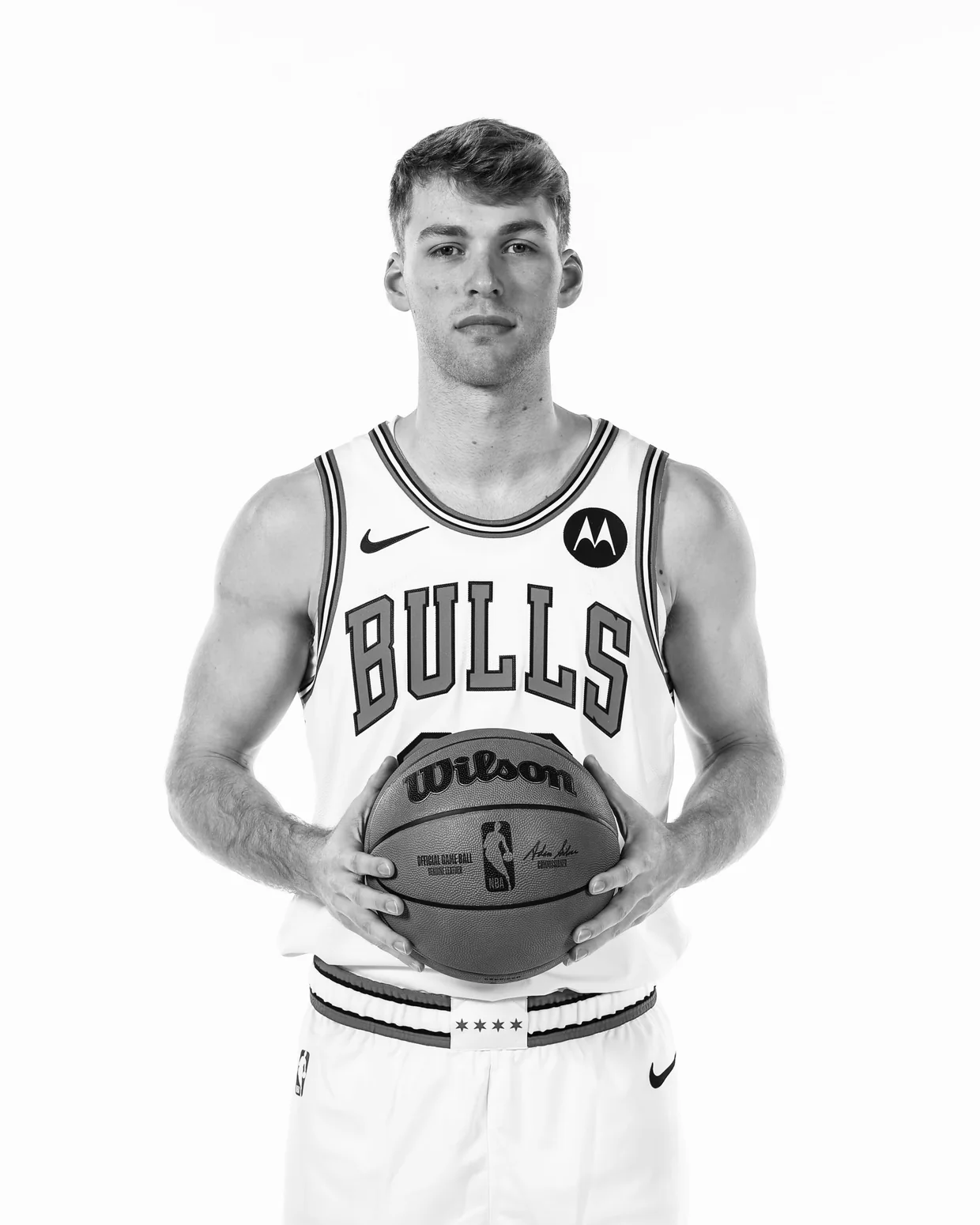 Marcus Domask in a Chicago Bulls basketball uniform holding a basketball